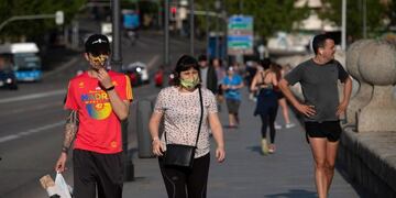 People walk along Segovia Bridge in Madrid on May 2, 2020, during the hours allowed by the government to go out and exercise, for the first time since the beginning of a national lockdown to prevent the spread of the COVID-19 disease\u002E - All Spaniards are again allowed to leave their homes since today to walk or play sports after 48 days of very strict confinement to curb the coronavirus pandemic\u002E After allowing children under 14 to go out since April 26, the government has again eased the conditions of the confinement imposed on March 14, which was one of the strictest in the world\u002E (Photo by PIERRE-PHILIPPE MARCOU / AFP)