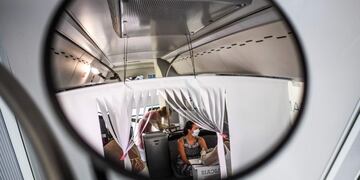 A woman undergoes a coronavirus test inside a bus converted into a test lab at the Sao Domingos de Rana high school in Cascais on September 14, 2020\u002E - A coronavirus bus travelled through several schools in Cascais in the outskirts of Lisbon to deliver free COVID-19 tests to teachers and school employees days before the beginning of the academic year\u002E (Photo by PATRICIA DE MELO MOREIRA / AFP)