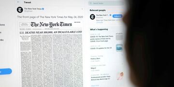 This picture taken on May 23, 2020, in Los Angeles, California, shows a woman looking at a computer screen with a tweet by the New York Times newspaper account showing the early edition front page of May 24, 2020, with a list of 1,000 names printed on it, that represents 1% of the lives lost due to the novel coronavirus pandemic, COVID-19, in the US\u002E (Photo by Agustin PAULLIER / AFP)