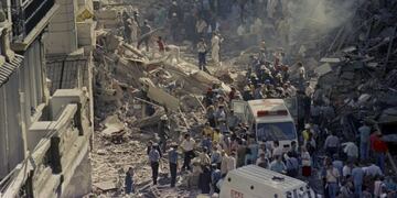 In this March 17, 1992 file photo, firemen and rescue workers walk through the debris of Israel's Embassy after a terrorist attack in Buenos Aires, Argentina. Israel summoned the Argentinian ambassador on Tuesday Jan. 29, 2013 in protest over an agreement