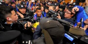 Argentine striker Carlos Tevez makes his way through the arrivals halls at Shanghai Pudong International Airport in Shanghai on January 19, 2017. nTevez arrived to a rousing welcome from hundreds of fans in Shanghai, where he will join local side Shenhua