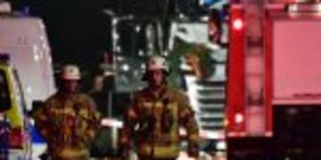 Fireworkers walk in front of the truck that speeded into a christmas market in Berlin, on December 19, 2016 killing at least one person and injuring at least 50 people.nAmbulances and heavily armed officers rushed to the area after the driver drove up the