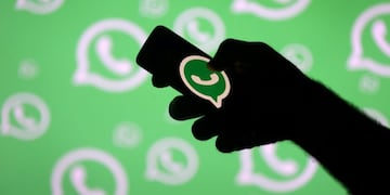 FILE PHOTO: A man poses with a smartphone in front of displayed Whatsapp logo in this illustration September 14, 2017\u002E REUTERS/Dado Ruvic/File Photo