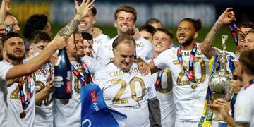 Soccer Football - Championship - Leeds United v Charlton Athletic - Elland Road, Leeds, Britain - July 22, 2020 Leeds United players and manager Marcelo Bielsa celebrate winning the Championship and promotion to the Premier League, as play resumes behind closed doors following the outbreak of the coronavirus disease (COVID-19) Action Images via Reuters/Lee Smith