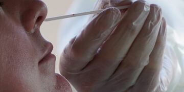 A Salt Lake County Health Department public health nurse performs a coronavirus test outside the Salt Lake County Health Department, Tuesday, Nov\u002E 3, 2020, in Salt Lake City\u002E (AP Photo/Rick Bowmer)