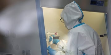A health worker analyzes samples collected during mass coronavirus testing inside a mobile laboratory in Jakarta, Indonesia, Thursday, June 18, 2020\u002E (AP Photo/Achmad Ibrahim)