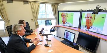 Handout picture released by the Argentine presidency showing Argentina's President Alberto Fernandez (L) and his Secretary of Strategic Affairs Secretary Gustavo Beliz holding a video conference with the World Bank Managing Director of Operations Axel van Trotsenburg, from the presidential residence in Olivos, Buenos Aires, on March 25, 2020\u002E - The World Bank approved a loan of 300 million US dollars in budgetary support for Argentina to strengthen the social protection system and minimize the impact of the COVID-19 crisis on the most vulnerable sectors\u002E It aims to strengthen the National Social Security Administration's (ANSES) Child and Youth Protection Project\u002E (Photo by Esteban COLLAZO / Argentinian Presidency / AFP) / RESTRICTED TO EDITORIAL USE - MANDATORY CREDIT \