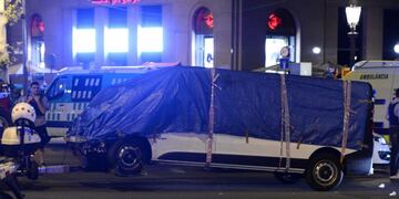 The van who ploughed into the crowd, killing at least 13 people and injuring around 100 others is towed away from the Rambla in Barcelona on August 18, 2017\u002E\r\nA driver deliberately rammed a van into a crowd on Barcelona's most popular street on August 17, 2017 killing at least 13 people before fleeing to a nearby bar, police said\u002E \r\nOfficers in Spain's second-largest city said the ramming on Las Ramblas was a \
