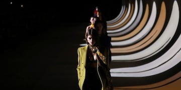 FILE - In this Feb\u002E 25, 2020 file photo, model Kaia Gerber leads other models as they wear creations for the Saint Laurent fashion collection during Women's fashion week Fall/Winter 2020/21 presented in Paris\u002E The coronavirus pandemic has instilled extra unpredictability into the already fickle Paris Fashion Week\u002E After first canceling the July shows for menswear and Haute Couture, the French fashion federation has now organized an unprecedented schedule of digital-only events instead\u002E (Photo by Vianney Le Caer/Invision/AP, File)
