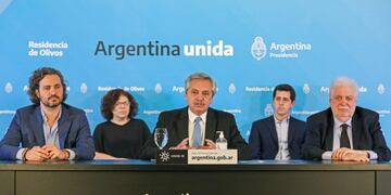 Handout picture released by the Argentina's Presidency showing President Alberto Fernandez (C), flanked by his Health Minister Gines Garcia (R) and his chief cabinet Santiago Cafiero (L), announcing the extension of the \