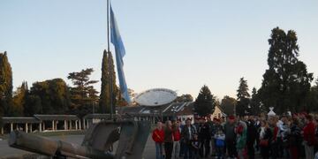 Originalmente, era: La histórica bandera del Grupo 4, exhibida en el momento de la ceremonia, junto a los veteranos que la defendieron; y un cañón como los que llevaron.