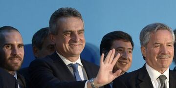 Argentina's new Defense Minister Agustin Rossi (C) waves next to Argentina's new Economy Minister Martin Guzman (L) and Argentina's Foreign Minister Felipe Sola (R), during their swearing in ceremony at the Casa Rosada presidential palace, in Buenos Aires, on December 10, 2019\u002E - Center-leftist Alberto Fernandez vowed to put his people first ahead of debt repayments after he was sworn in as Argentina's president on Tuesday to singing and applause from lawmakers and supporters\u002E (Photo by JUAN MABROMATA / AFP)