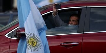 A demonstrator holds his phone from his car during a protest against the state takeover of agro exporter Vicentin and against COVID-19 quarantine measures in Buenos Aires, Argentina June 20, 2020\u002E REUTERS/Agustin Marcarian