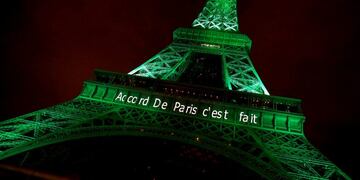 FILE PHOTO: The Eiffel tower is illuminated in green with the words \