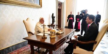 Pope Francis and President of Slovenia Borut Pahor sit at a table as they speak on the occasion of their private audience, at the Vatican, Monday, Oct. 17, 2016.  (Andreas Solaro/Pool Photo via AP)