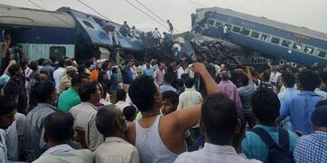 Railway police and local volunteers look for survivors in the upturned coaches of the Kalinga-Utkal Express after an accident near Khatauli, in the northern Indian state of Uttar Pradesh, Saturday, Aug\u002E 19, 2017\u002E Six coaches of a passenger train derailed in northern India on Saturday, killing more than 20 people and injuring dozens, officials said\u002E (AP Photo)