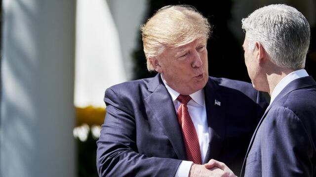 U.S. Supreme Court Justice Neil Gorsuch, right, shakes hands with U.S. President Donald Trump after taking the oath of office during a ceremony in the Rose Garden at the White House in Washington, D.C., U.S., on Monday, April 10, 2017. Trump said Gorsuch