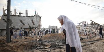 Una mujer palestina mira los edificios destruidos el primer día de la festividad de Eid al-Fitr, que marca el final del mes de ayuno musulmán del Ramadán, en la ciudad de Beit Lahia, en el norte de la Franja de Gaza.