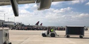 Photo courtesy of Taylor Elenburg shows Passengers gathering on the tarmac of the Fort Lauderdale-Hollywood airport in Florida after a gunman opened fire on January 06, 2017. nA gunman opened fire Friday at Fort Lauderdale-Hollywood airport in Florida, ca
