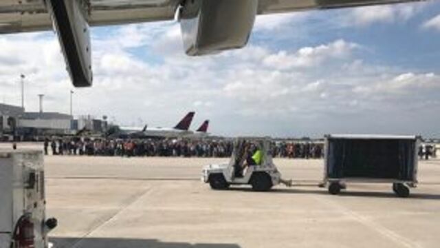 Photo courtesy of Taylor Elenburg shows Passengers gathering on the tarmac of the Fort Lauderdale-Hollywood airport in Florida after a gunman opened fire on January 06, 2017. nA gunman opened fire Friday at Fort Lauderdale-Hollywood airport in Florida, ca