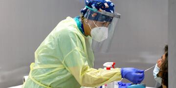 A healthcare worker wearing personal protective equipment (PPE) collects a swab sample from a passenger at the Covid-19 rapid test facility at Fiumicino Airport in Rome, Italy, on Friday, Sept\u002E 25, 2020\u002E A handful of airports are implementing trials of quick-fire coronavirus tests, working with airlines to push technologies still being developed as a way to revive stunted international air travel\u002E Photographer: Alessia Pierdomenico/Bloomberg