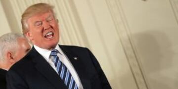 U.S. President Donald Trump reacts as he leaves with Vice President Mike Pence (L) after attending a swearing in ceremony for senior staff at the White House in Washington, DC January 22, 2017. REUTERS/Carlos Barria