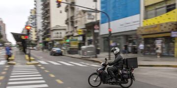 A delivery motorbike crosses Cabildo Avenue in the Belgrano neighborhood of Buenos Aires, Argentina, on Monday, April 27, 2020\u002E The coronavirus lockdown is forcing savers to get creative about the way they use the black market to evade strict currency controls introduced in September, and ditch depreciating pesos for the safe haven of dollars\u002E Photographer: Sarah Pabst/Bloomberg