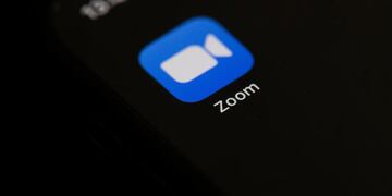 (FILES) In this illustration file photo taken on May 27, 2020, shows the logo of the social network application Zoom on the screen of a phone in Paris\u002E - Zoom on July 15, 2020, set out to capitalize on its pandemic-powered popularity with a touchscreen display tuned to its video-conferencing platform\u002E \