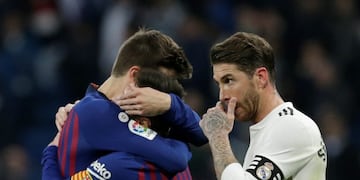 Real Madrid's Sergio Ramos, right, walks past Barcelona players Gerard Pique, left, and Lionel Messi as they celebrate after winning the Spanish La Liga soccer match between Real Madrid and FC Barcelona at the Bernabeu stadium in Madrid, Saturday, March 2, 2019\u002E (AP Photo/Andrea Comas)