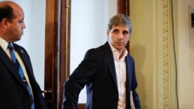 Argentina's new Finance Minister Luis Caputo arrives for a news conference at Casa Rosada presidential palace in Buenos Aires, Argentina, Friday, Dec. 30, 2016. Caputo and Argentina's new Treasury Minister Nicolas Dujovne replace outgoing Finance Minister
