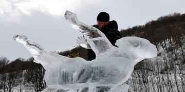 Russian ice sculptor Andrey Molokov works on his ice sculpture called \
