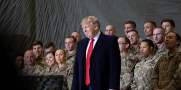 FILE - In this Nov\u002E 28, 2019, file photo President Donald Trump smiles before addressing members of the military during a surprise Thanksgiving Day visit at Bagram Air Field, Afghanistan\u002E Trump has held himself up as a champion of U\u002ES\u002E troops without rival\u002E Now, with his presidency on the line, he’s casting suspicion on a tool of participatory democracy, the mail-in ballot, that has allowed U\u002ES\u002E military personnel to participate in elections while serving far from home since the War of 1812\u002E (AP Photo/Alex Brandon, File)