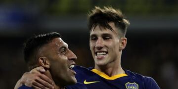 Boca Juniors' forward Ramon Abila (L) celebrates with his teammate midfielder Nicolas Capaldo after scoring a goal against Argentinos Juniors during their Argentina First Divison 2019 Superliga Tournament football match at La Bomboneral stadium, in Buenos Aires, on November 30, 2019\u002E (Photo by ALEJANDRO PAGNI / AFP)