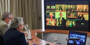 Handout picture released by Argentina's Presidency showing Argentine President Alberto Fernandez (R) and his Foreign Minister Felipe Sola taking part in the first Mercosur Summit held via video conference due to the COVID-19 novel coronavirus pandemic, from Olivos Presidential Residence in Olivos, Buenos Aires, on July 2, 2020\u002E - The leaders of the South American trade bloc Southern Common Market, the presidents of Argentina, Alberto Fernandez; from Brazil, Jair Bolsonaro; from Paraguay, Mario Abdo; and from Uruguay, Luis Lacalle, intend to put aside their political differences and focus on strengthening new markets for their exports, mainly agricultural\u002E (Photo by ESTEBAN COLLAZO / Argentinian Presidency / AFP) / RESTRICTED TO EDITORIAL USE - MANDATORY CREDIT \