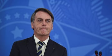 Brazil's President Jair Bolsonaro speaks to journalists about the new coronavirus at Planalto presidential palace in Brasilia, Brazil, Friday, March 27, 2020\u002E Even as coronavirus cases mount in Latin America’s largest nation, Bolsonaro is calling the pandemic a momentary, minor problem and saying strong measures to contain it are unnecessary\u002E (AP Photo/Andre Borges)