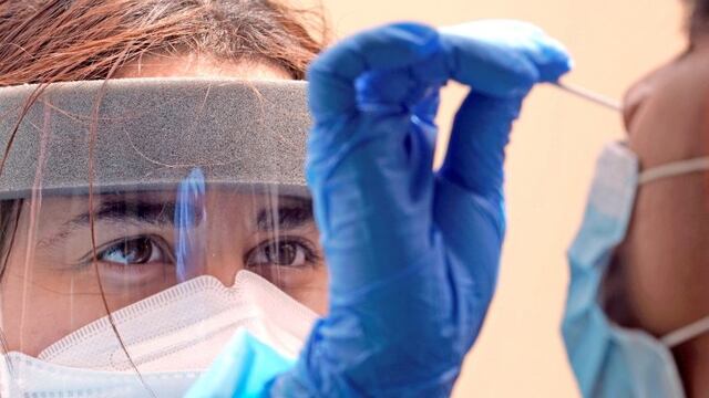 Medical student Kimberly Olivares, left, takes a sample from a patient at a free COVID-19 testing site provided by United Memorial Medical Center, Sunday, June 28, 2020, at the Mexican Consulate, in Houston\u002E Confirmed cases of the coronavirus in Texas continue to surge\u002E On Friday, Texas Gov\u002E Greg Abbott shut down bars again and scaled back restaurant dining as cases climbed to record levels after the state embarked on one of America's fastest reopenings\u002E (AP Photo/David J\u002E Phillip)