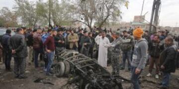 Security forces and citizens inspect the scene after a car bomb explosion at a crowded outdoor market in the Iraqi capital's eastern district of Sadr City, Iraq, Monday, Jan 2, 2017. (AP Photo/ Karim Kadim)
