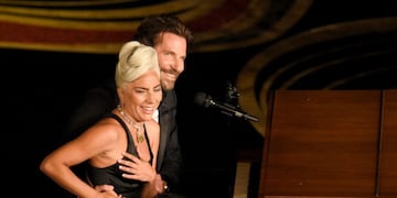 Lady Gaga, left, and Bradley Cooper react to the audience after a performance of \