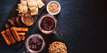 beer and snacks\u002E bar table\u002E restaurant, pub, food concept\u002E craft lager drink, salted nuts and breaded fried cheese\u002E friday party atmosphere, craft brewery background