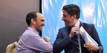 13 March 2020, Argentina, Buenos Aires: Nicolas Trotta (R), Argentina's education minister, taps elbows with a colleague before a press conference on school and university activities in the context of the coronavirus prevention measures\u002E Photo: Victor Carreira/telam/dpa
