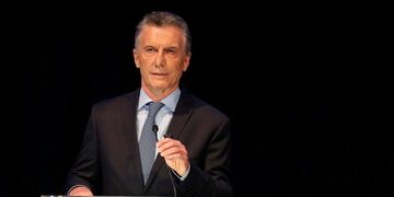 FILE PHOTO: Argentina presidential candidate Mauricio Macri adjusts his microphone at a presidential debate, ahead of the October 27 presidential election, at the Litoral University in Santa Fe, Argentina,  October 13, 2019\u002E REUTERS/Agustin Marcarian/File Photo
