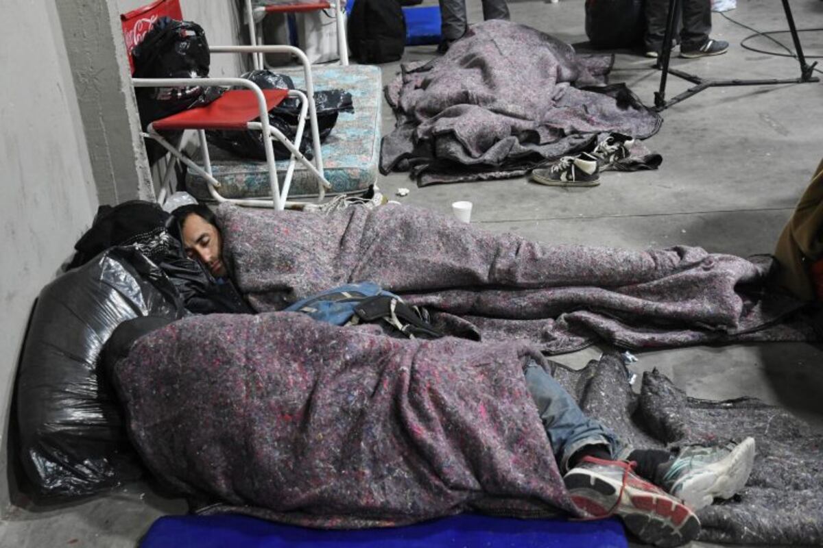 04 July 2019, Argentina, Buenos Aires: Two men sleep on the floor in the Monumental Stadium\u002E Argentina's River Plate football club took homeless people into their stadium because of the cold temperatures in the Argentine capital\u002E Photo: Amarelle Gustavo/telam/dpa