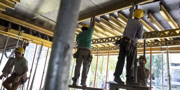 Workers install metal beams at the Hornos 330 Master Office 3 building under construction in Buenos Aires, Argentina, on Friday, Nov\u002E 25, 2016\u002E The Argentina National Institute of Statistics and Censuses (INDEC) is scheduled to release construction activity figures on November 30\u002E Photographer: Sarah Pabst/Bloomberg buenos aires  leve repunte en la industria de la construccion crisis economica recesion obras en construccion