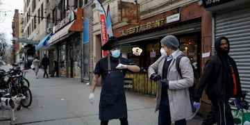 Chef Jorge Cardenas shares an elbow bump with regular Ix customer Lorenzo Bernasconi outside of Ix restaurant in the Brooklyn borough of New York City, U\u002ES\u002E, April 2, 2020 amid the coronavirus disease (COVID-19) outbreak\u002E Picture taken April 2, 2020\u002E REUTERS/Anna Watts NO RESALES\u002E NO ARCHIVES