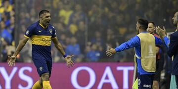Argentina's Boca Juniors forward Ramon Abila (L) celebrates with teammate forward Carlos Tevez (2-R) after scoring a goal against Brazil's Athletico Paranaense during a Copa Libertadores sixteen round second leg football match at the \