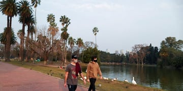 Two men take a walk at the lake in the 3 de Febrero park as the government begins to ease quarantine restrictions imposed to slow the spread of the coronavirus disease (COVID-19), in Buenos Aires, Argentina July 20, 2020\u002E REUTERS/Agustin Marcarian