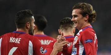 Atletico Madrid's French forward Antoine Griezmann (R) celebrate after scoring the 0-2 goal with his teammate Koke during the UEFA Champions League round of 16 first-leg football match between Bayer 04 Leverkusen and Club Atletico de Madrid in Leverkusen,