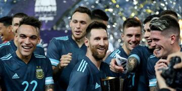 Soccer Football - International Friendly - Brazil v Argentina - King Saud University Stadium, Riyadh, Saudi Arabia - November 15, 2019 Argentina's Lionel Messi celebrates with a trophy alongside Lautaro Martinez and teammates after the match REUTERS/Ahmed Yosri