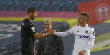 Manchester City's Ruben Dias, left, and Leeds United's Rodrigo shake hands at the end of the English Premier League soccer match between Leeds United and Manchester City at Elland Road in Leeds, England, Saturday, Oct\u002E 3, 2020\u002E (Jason Cairnduff/Pool via AP)