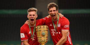 Bayern Munich's German midfielder Joshua Kimmich (L) and Bayern Munich's German midfielder Leon Goretzka celebrate with the German Cup (DFB Pokal) trophy after winning the final football match Bayer 04 Leverkusen v FC Bayern Munich at the Olympic Stadium in Berlin on July 4, 2020\u002E (Photo by Alexander Hassenstein / POOL / AFP) / DFB REGULATIONS PROHIBIT ANY USE OF PHOTOGRAPHS AS IMAGE SEQUENCES AND QUASI-VIDEO\u002E